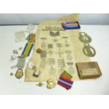 A COLLECTION OF MILITARY BADGES, MEDAL RIBBONS, HORSE BRASSSES ETC