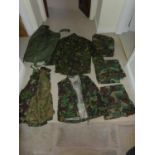 A LARGE COLLECTION OF MILITARY/SHOOTING/FISHING CAMOUFLAGE UNIFORMS TO INCLUDE U.S. ARMY WITH