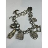 A SILVER CHARM BRACELET WITH EIGHT CHARMS