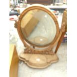 A CARVED MAHOGANY DRESSING TABLE MIRROR