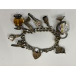 A SILVER CHARM BRACELET WITH TEN CHARMS
