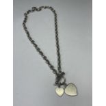 A SILVER T BAR NECKLACE WITH HEART PENDANTS