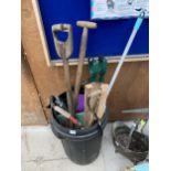 A DUSTBIN CONTAINING A LARGE QUANTITY OF TOOLS TO INCLUDE SAWS AND SPADES ETC