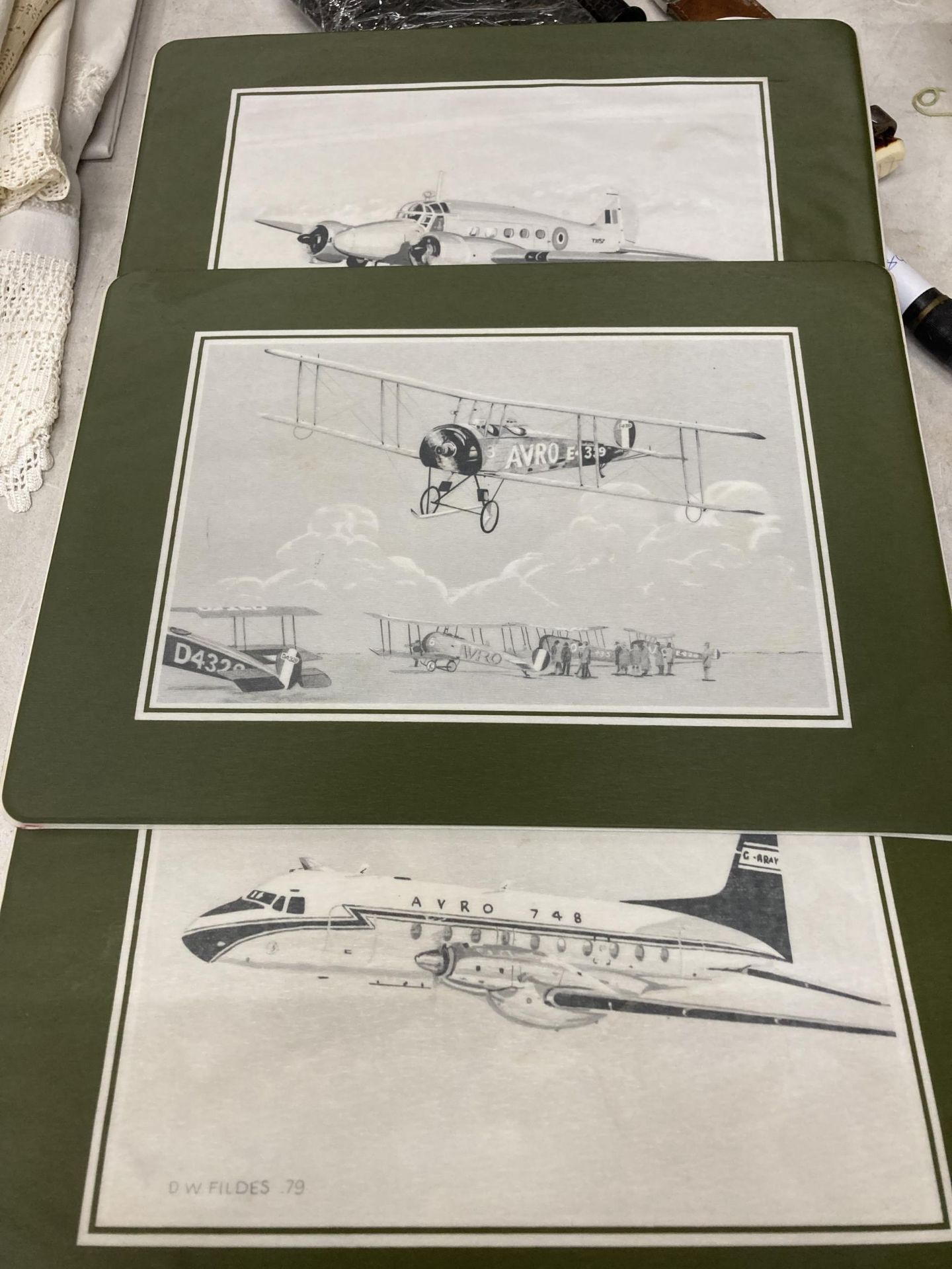 A SET OF SIX BRITISH AEROSPACE PLASTIC PLACEMATS FEATURING DIFFERENT AVRO AIRCRAFT, SIGNED AND DATED