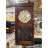 A VINTAGE MAHOGANY CASED WALL CLOCK WITH BEVELLED GLASS TO THE FRONT