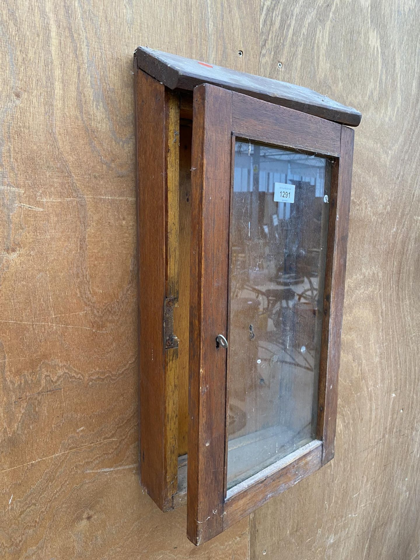 A VINTAGE WOODEN AND GLAZED WALL DISPLAY CABINET