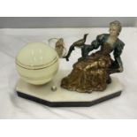 AN UNUSUAL DECO LAMP WITH PIANTED BRASS LADY WITH A PEACOCK, GLOBE SHAPED SHADE ON A MARBLE BASE