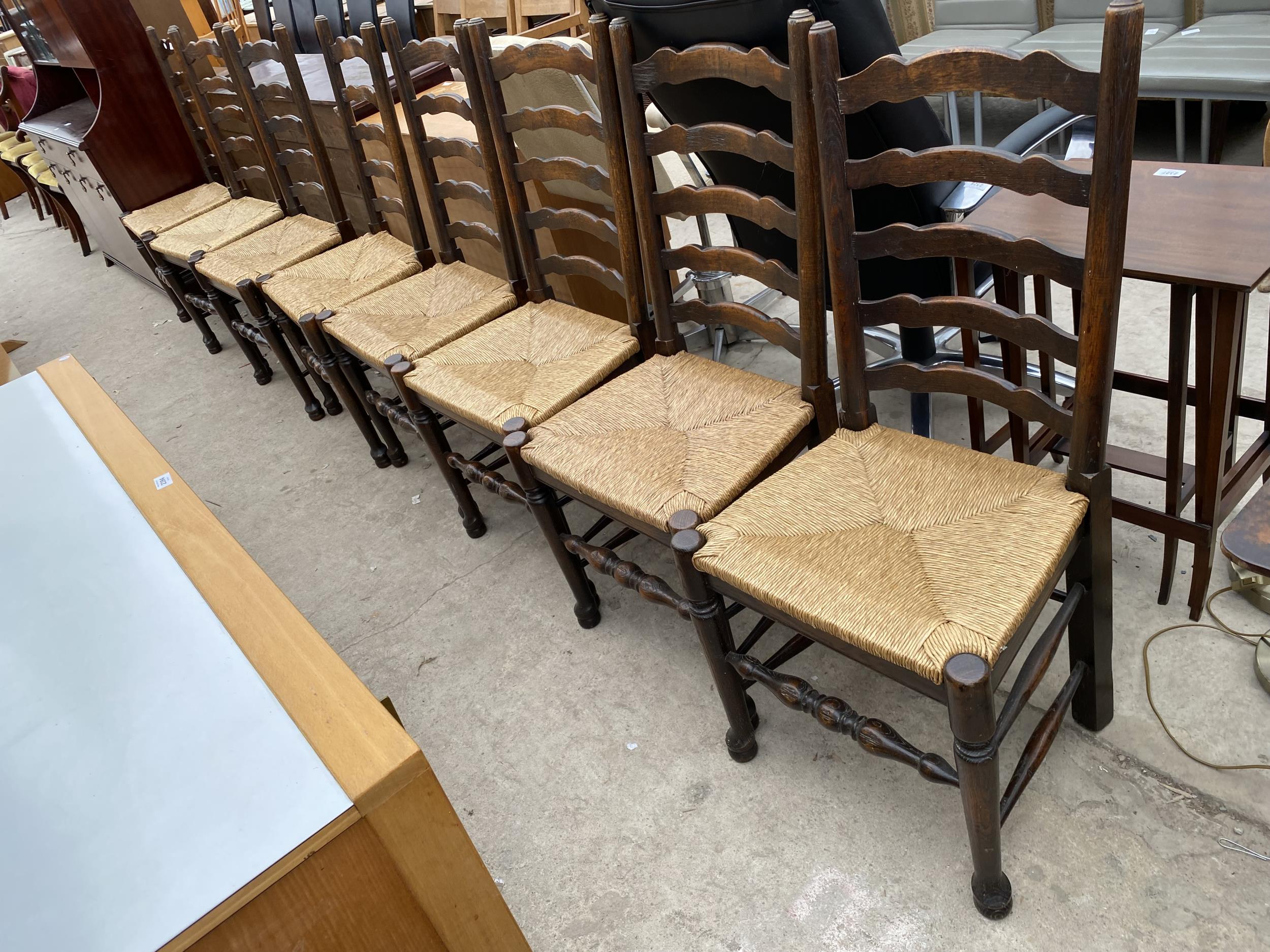 A SET OF EIGHT LANCASHIRE STYLE LADDER BACK DINING CHAIRS WITH RUSH SEATS