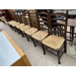 A SET OF EIGHT LANCASHIRE STYLE LADDER BACK DINING CHAIRS WITH RUSH SEATS