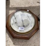 A VINTAGE OCTAGONAL WOODEN CASED BAROMETER