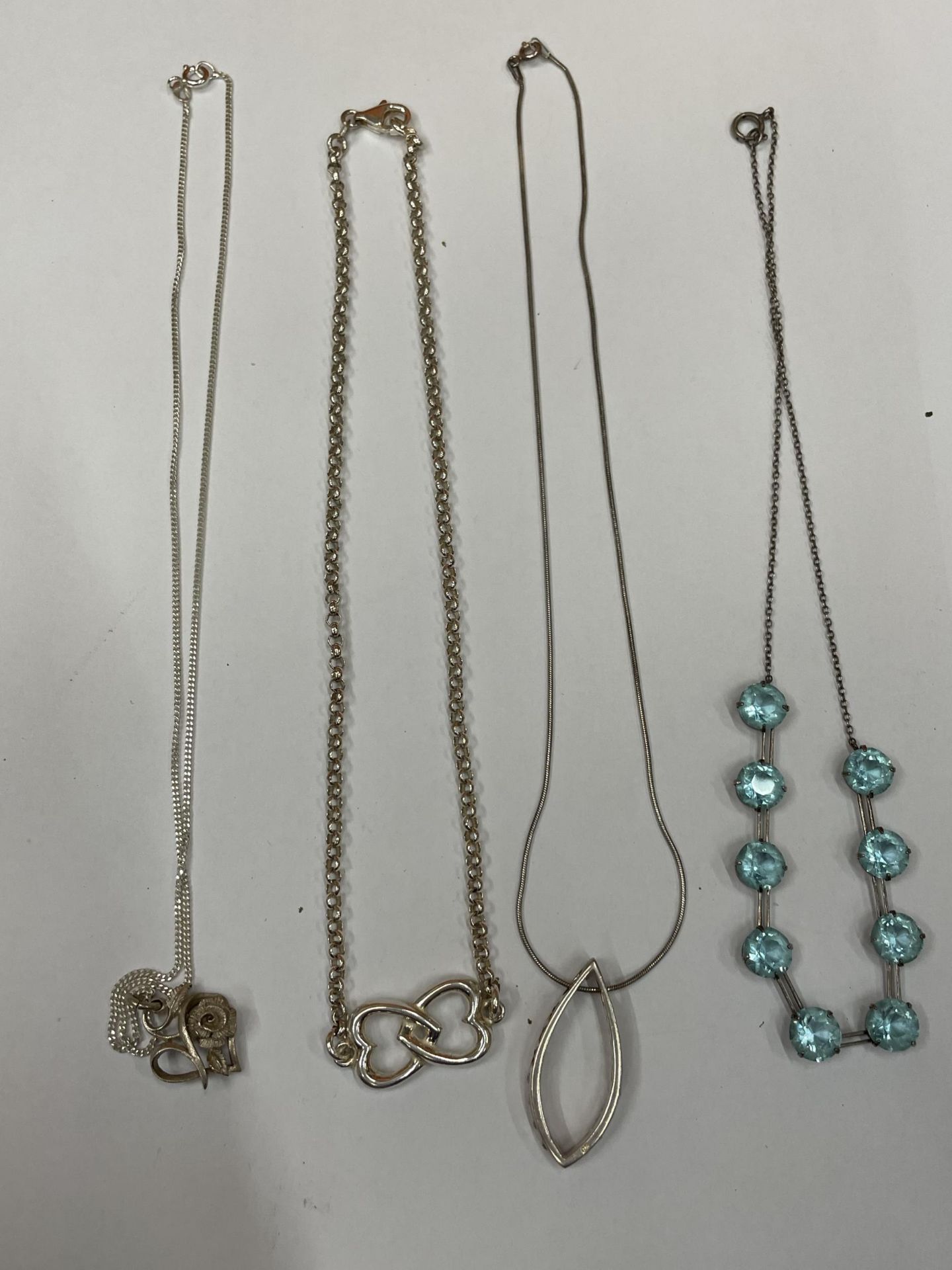 FOUR SILVER NECKLACES WITH PENDANTS