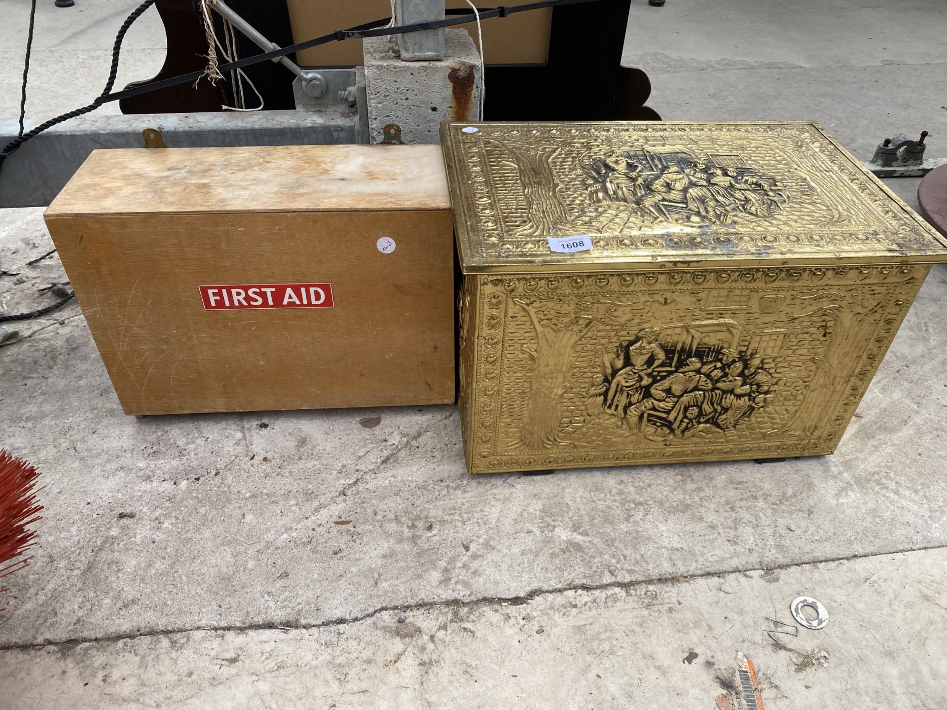 A WALL MOUNTED FIRST AID BOX AND A BRASS LOG BOX