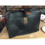 A VINTAGE BLACK LEATHER BRIEFCASE WITH CLASP FASTENING