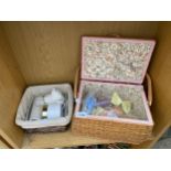 A WICKER BASKET CONTAING BAYLIS & HARDING TOILETRIES AND A FURTHER WICKER BASKET WITH CLIP ON BOWS
