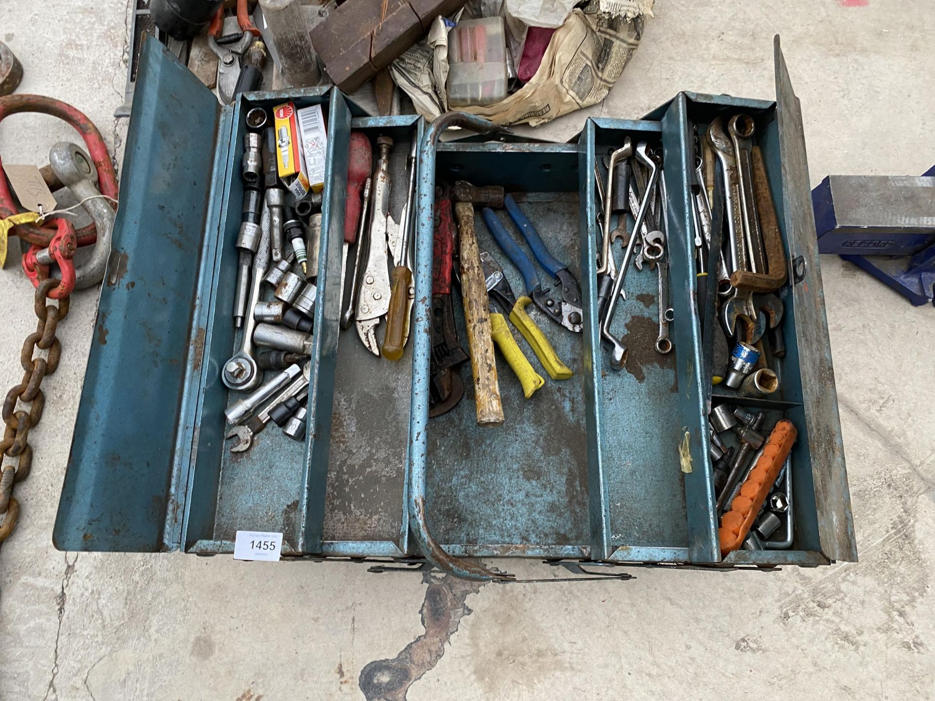 A METAL TOOL BOX CONTAING AN ASSORTMENT OF TOOLS TO INCLUDE SPANNERS, SOCKETS AND PLIERS ETC