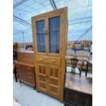 A MID 20TH CENTURY GLAZED AND LEADED TWO DOOR CUPBOARD ON BASE ENCLOSING DRAWER AND TWO CUPBOARDS,