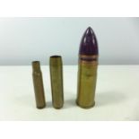 THREE BRASS SHELL CASES, ONE WITH PAINTED SHELL, HEIGHTS FROM 10CM TO 16CM