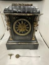 A HEAVY SLATE AND MARBLE MANTLE CLOCK WITH ENGRAVED FLOWER DECORATION AND LION HANDLES TO THE SIDE