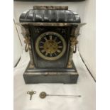 A HEAVY SLATE AND MARBLE MANTLE CLOCK WITH ENGRAVED FLOWER DECORATION AND LION HANDLES TO THE SIDE