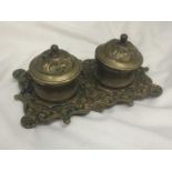 A VINTAGE BRASS INKWELL WITH ORNATE DECORATION INCLUDING ONE LINER