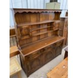 A GEORGE III STYLE BEVAN FUNNEL OAK DRESSER WITH THREE PANELLED DOORS TO THE BASE, THREE FRIEZE