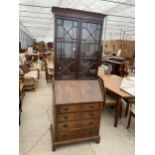 AN EDWARDIAN ASTRAGAL GLAZED TWO DOOR BUREAU BOOKCASE WITH FITTED INTERIOR AND FOUR GRADUATED