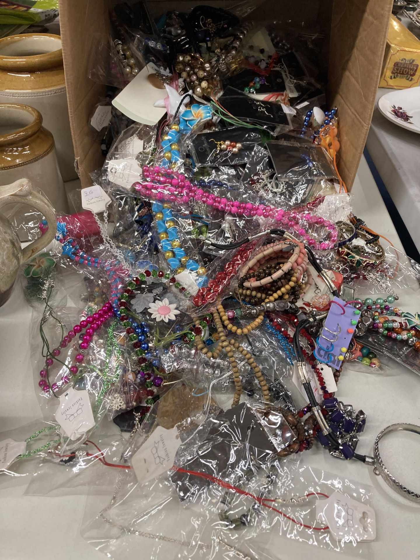 A LARGE QUANTITY OF COSTUME JEWELLERY TO INCLUDE BEADS, BANGLES, BRACELETS, EARRINGS, ETC