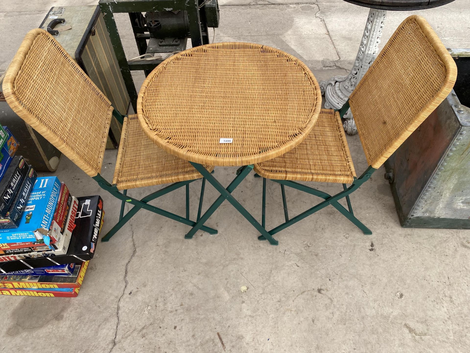 A FOLDING METAL AND WICKER BISTRO SET COMPRISING OF A ROUND TABLE AND TWO CHAIRS