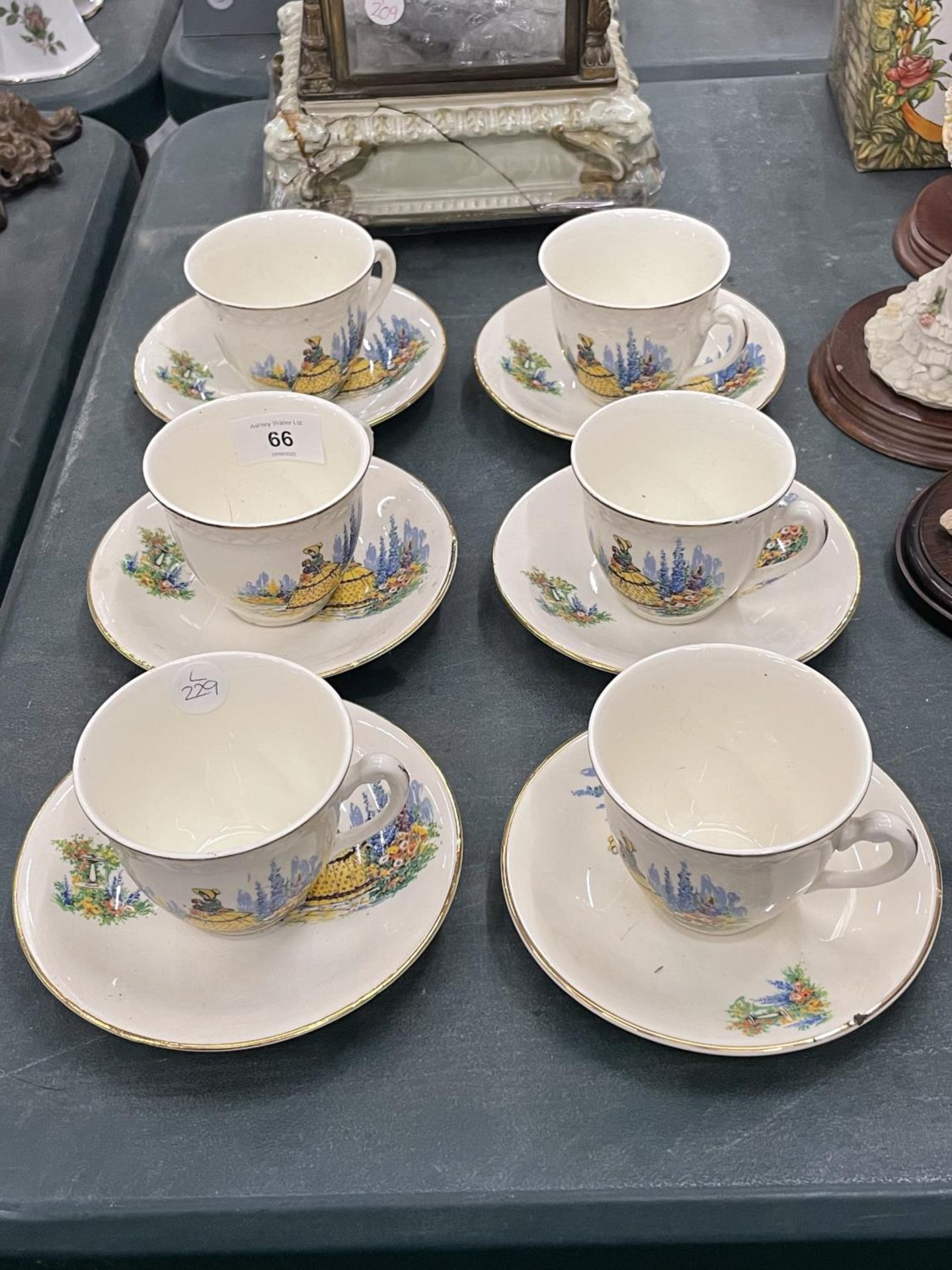 SIX VINTAGE CUPS AND SAUCERS WITH CRINOLINE DECORATION
