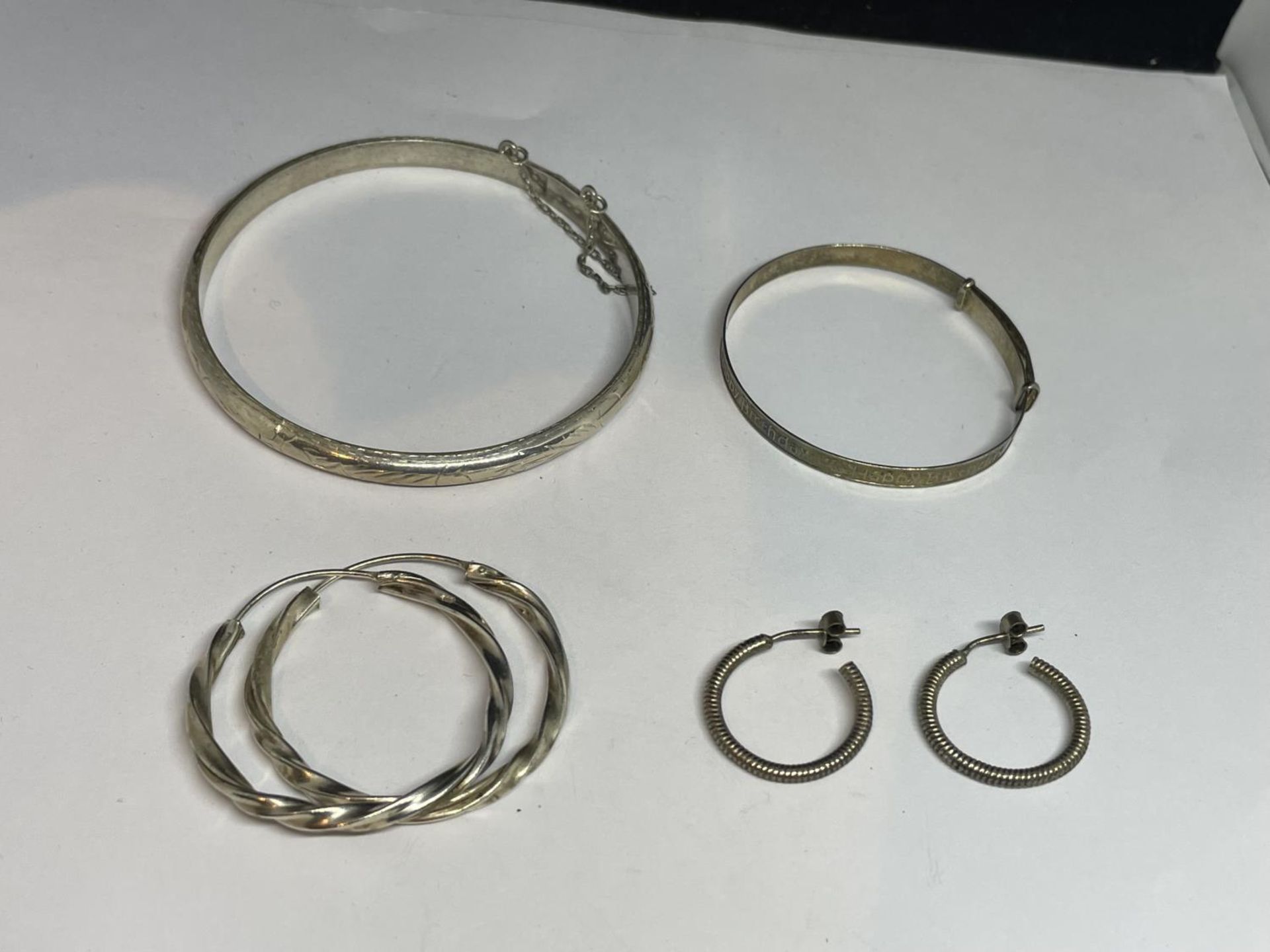 TWO MARKED SILVER BANGLES AND TWO PAIRS OF SILVER EARRINGS