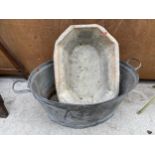 A TWIN HANDLED TIN BATH AND A FURTHER TIN TROUGH