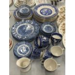 A LARGE QUANTITY OF BLUE AND WHITE PLATES, BOWLS, CUPS AND SAUCERS IN 'WILLOW' AND 'LIBERTY BLUE'
