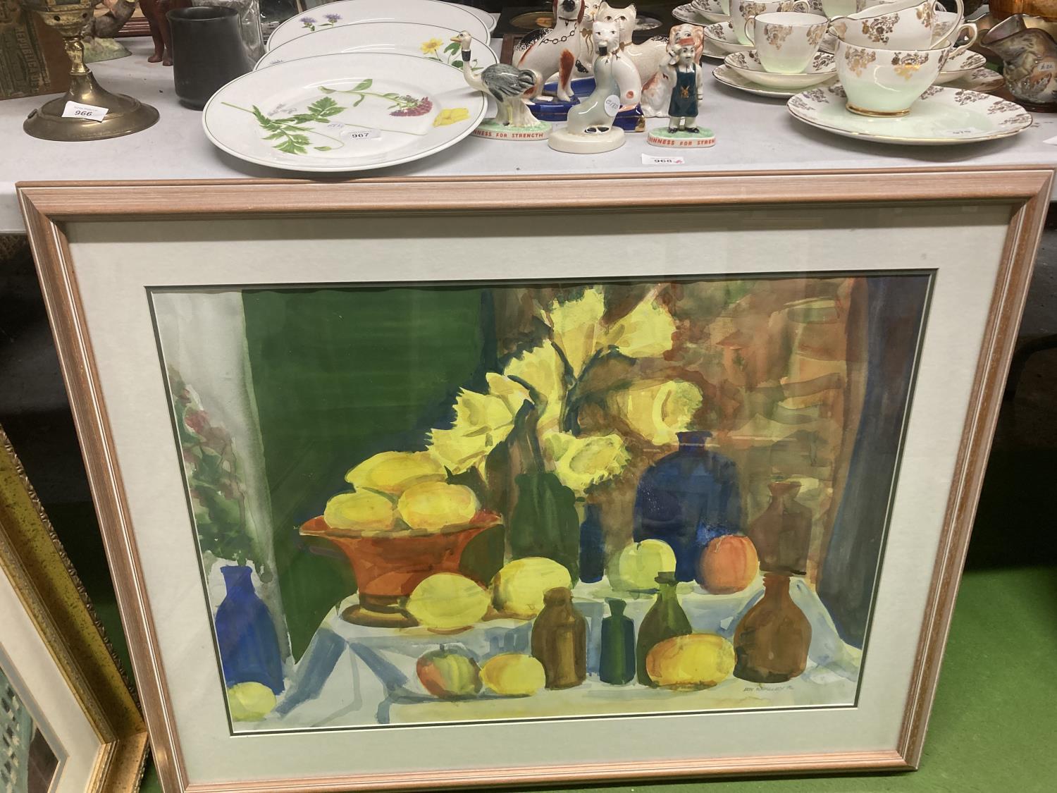 A STILL LIFE WATERCOLOUR OF DAFFODILS, FRUIT AND BOTTLES SIGNED DON WHALLEY, '96, FRAMED 91CM X 73CM