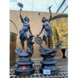 A NEAR PAIR OF SPELTER FEMALE FIGURES ON WOODEN PLINTHS, ONE BEARING THE LABEL 'L'INDUSTRIE' AND THE