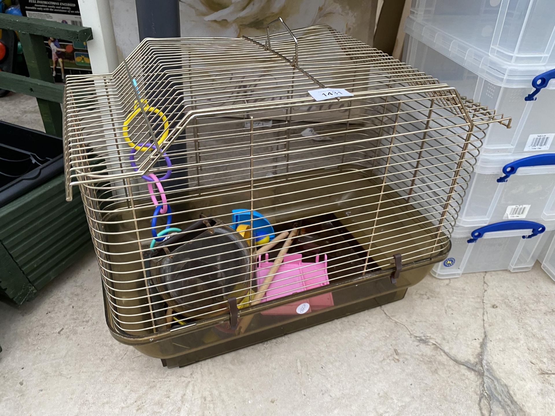 A SMALL BIRD CAGE WITH VARIOUS ACCESSORIES