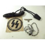 A NAZI GERMANY SS CLOTH BADGE, TWO LOTS OF BRAID AND AN EAGLE & SWASTIKA BADGE