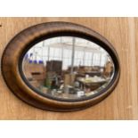 A WOODEN FRAMED BEVEL EDGED WALL MIRROR