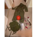 A MILITARY/OUTDOOR ADVENTURE COVERALL, RED HELMET, OVERBOOTS AND STRAPS ETC