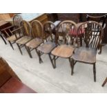 A SET OF SIX ELM AND BEECH WHEELBACK WINDSOR STYLE CHAIRS, ONE BEING A CARVER