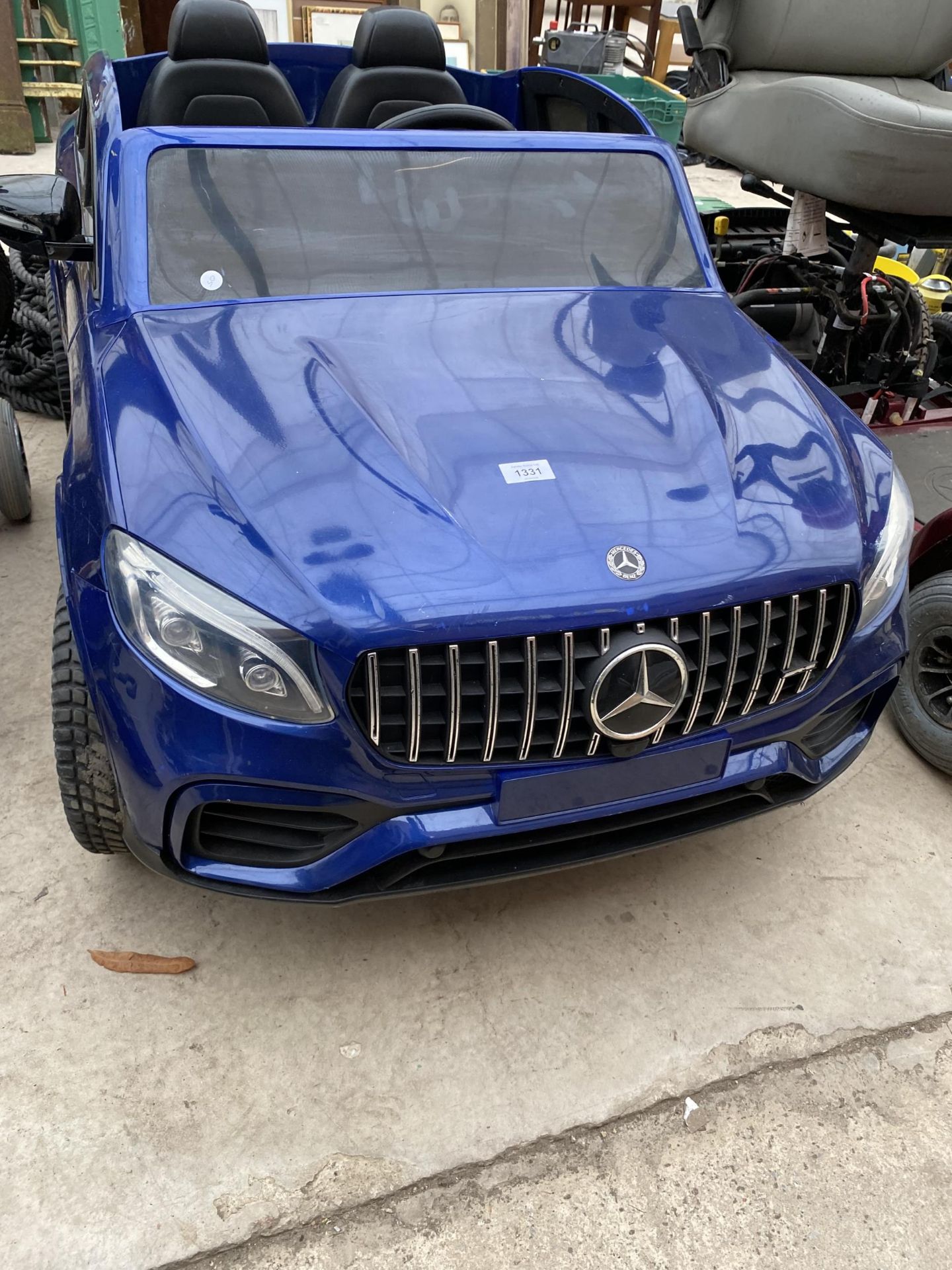 A MERCEDES BENZ CHILDRENS ELECTRIC CAR