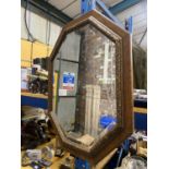 A WOODEN FRAMED OCTAGONAL BEVELLED MIRROR 79CM X 64CM