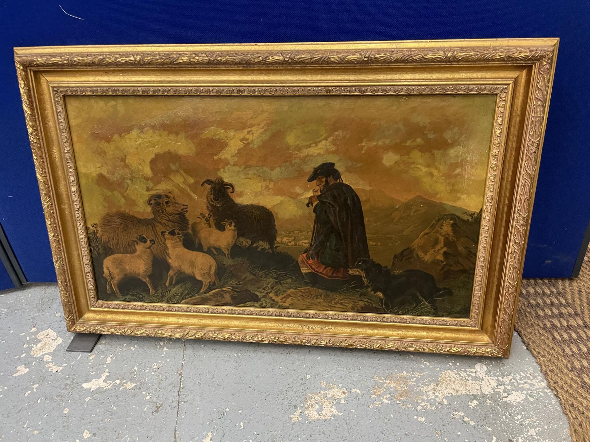 A BELIEVED VICTORIAN OLEOGRAPH OF A SCOTTISH SHEPHERD WITH SHEEP ON A MOUNTAINSIDE IN A GILT FRAME