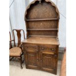 A REPRODUCTION OAK DUTCH STYLE DRESSER WITH LINENFOLD DOORS AND TWO DRAWERS 36" WIDE