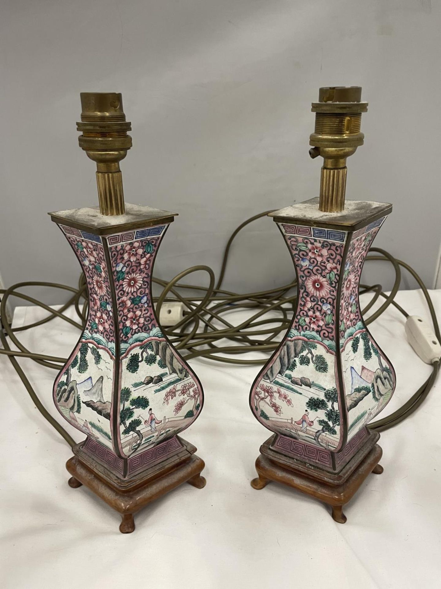 A PAIR OF UNUSUAL SHAPED ORIENTAL LAMPS PORCELAIN AND BRASS ON WOODEN BASE