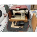 A RETRO CREAM NOVUM SEWING MACHINE WITH CARRY CASE