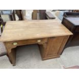 A VICTORIAN PINE SINGLE PEDESTAL DESKW ITH SINGLE CUPBOARD AND DRAWER WITH BRASS SCOOP HANDLES,