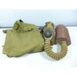 A WORLD WAR II GAS MASK AND BAG