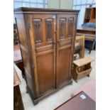 A MID 20TH CENTURY OAK TWO DOOR WARDROBE WITH GOTHIC PANELS, 37.5" WIDE