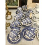 A LARGE QUANTITY OF BLUE AND WHITE CUPS AND SAUCERS PLUS A CREAM JUG AND SUGAR BOWL