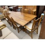 A MODERN HARDWOOD REFECTORY STYLE DINING TABLE ON THREE TURNED PILLAR ENDS, STRAIGHT STRETCHER,